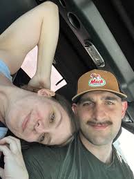 Can someone edit our photo to fix eyes, background, and arm appearance?