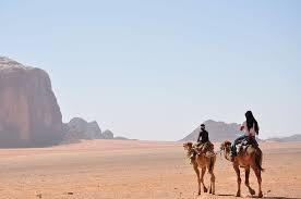 Ride through siq nugra and camp at sabbat. Hd Wallpaper Man And Woman Riding On Horse During Daytime Two Men Riding Camels Walking On Desert With View Of Brown Rock Formations During Daytime Photo Wallpaper Flare