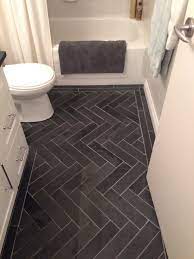 This herringbone marble floor from designer claire paquin really makes a statement in this sophisticated bathroom. Charcoal Gray Herringbone Honed Marble Floors In The Bathroom Www Houseandleisure Co Za Loves T Slate Bathroom Floor Small Bathroom Remodel Bathrooms Remodel