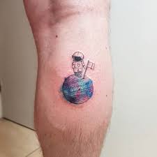 Astronaut sitting on moon tattoo. Small Astronaut Tattoo With Flag Astronaut Tattoo Tattoos Tattoo Designs