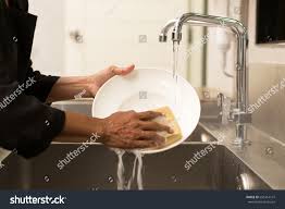 woman washing dishes kitchen sink