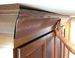 Hold the second piece of crown tight against the first piece, then nail it to the cabinets. Hiding A Wavy Ceiling In Crown Molding Fine Homebuilding