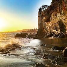 One of the most unique and mysterious landmarks of southern california is the tower that stands at the base of a cliff in laguna beach. A Visit To Victoria Beach In Laguna Beach Popsicle Blog