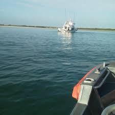 Coast Guard Assists 7 People On Grounded Flooding Boat In