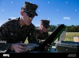 LCpl. Truong Nguyenbolia and Pfc. William Mayberry, riflemen with 3rd  Battalion, 6th Marine Regiment, input grid coordinates and prepare the  RQ-11B Raven Unmanned Air Vehicle during a qualification course for the UAV