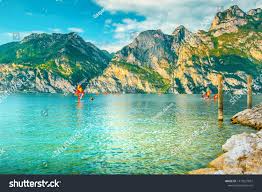 Popular Summer Holiday And Leisure Location Surfers Exercising In Lake Near Riva Del Garda Resort Lake Garda Italy Europe Ad Surfer Surfing Lake Garda
