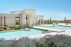 Among Ancient Rock Caves A Classical Greek Amphitheatre Olive Groves And A Private Bay The Greek Amanzoe Hotel Wi Greece Hotels Greece Design Greece Resorts