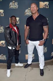 One might only reach the other's shoulder but he's pretty damn feisty when it comes to giving chat back. Kevin Hart And Dwayne Johnson Share Their Worst High School Memories Essence