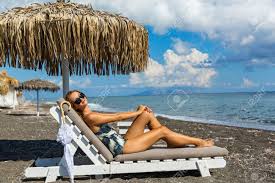 Beautiful Young Woman Sunbathing On The Beach In A Lounge Chair Stock Photo Picture And Royalty Free Image Image 72438059
