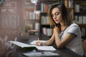 Girl Sitting At Table With Notebooks Writing Free Photo Language Translation Elearning Ielts