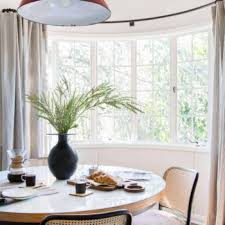 Bow windows are designed to create space by projecting beyond the exterior wall of a building. 9 Solutions For How To Dress Awkward Windows