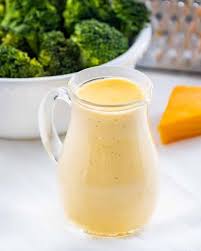 An Exquisite Creamy Cheese Sauce Made With Cheddar Cheese Perfect Over Nachos Pasta Potatoes And Steamed Vege In 2020 Creamy Cheese Sauce Steam Vegetables Recipes