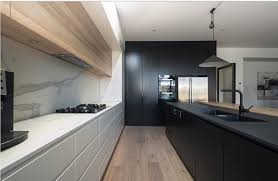 This creamy colored kitchen gets drama from the dark wood beams, countertop and window trim from one posh place. 20 Modern Black And White Kitchens That Used Wood Home Design Lover