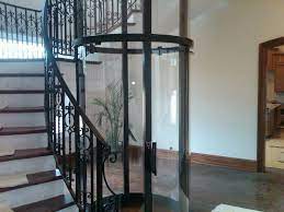 Glass Panel Home Elevator Fits Perfectly Inside A Spiral Staircase Exclusively By Nationwide Lifts House Construction Diy House Design House Elevation