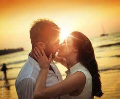 Romantic couple kissing on a hot, tropical beach Stock Photo | Adobe Stock