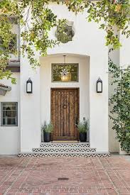 Black And White Spanish Style Home Exterior Antique Feel Meets New Vibes To Create A Front Door With Character And Style Mediterranean Style Homes Spanish Style Homes House Exterior