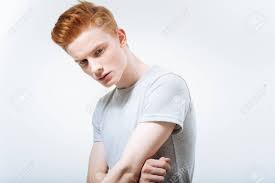 Depressed Young Pretty Guy Crossing Arms While Staring Down And Posing On  The Isolated Background Stock Photo, Picture and Royalty Free Image. Image  94365608.