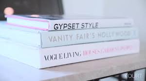 The Living Room Table Is Decoreted With A Lot Of Coffee Table Books Kardashian Home Gypset Style Living Room Table