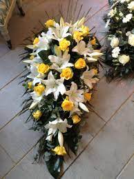 Luxury funeral wreath with yellow flowers on a white striped isolated background. Funeral Flowers White Lily And Yellow Rose Funeral Spray Casket Spray Funeral Flowers Www Theflo Funeral Flowers Funeral Flower Arrangements Casket Flowers
