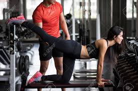 Personal Trainer Helping Asian Young Fit Girl In Leg Stretching Workout On  Bench At Gym Fitness. Bodybuilding And Healthy Lifestyle. Adjust Knee And  Calf Position. Stock Photo, Picture and Royalty Free Image.
