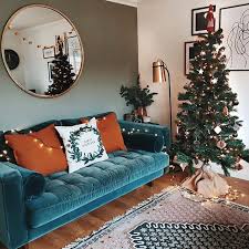 Blue Made Com Velvet Sofa With Orange Cushions French Connection Rug And Christmas Tree Mirroring The Home Living Room House Interior Living Room Inspiration