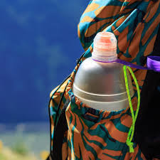 Person Drinking from a Sports Water Bottle while Running