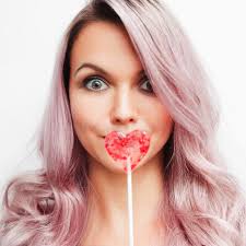 Lovely Charming Girl with a Lollipop in the Form of Heart. Portrait of a  Young Woman with Pink Hair and Pink Candy Stock Image