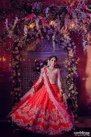 This tarun red wedding lengha has an asymmetric jacket blouse matched with a heavily embroidered shaded red skirt. Stunning Red Lehenga Designs That We Loved On Real Brides