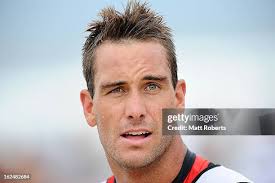 Wes Berg runs out of the water after the swim portion during the... News  Photo