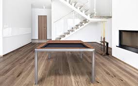 A linear chandelier illuminates the wooden dining set in this modern dining room with tile flooring and glass sliders that open to the balcony with an expansive view. Contemporary Dining Table Pronto Ultra Jsc Bilijardai Steel Hpl Steel Base