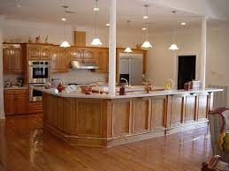 Oak Kitchen Cabinets With Hanging Light Fixtures And Hardwood Floors I Love The Arch Pattern Light Oak Cabinets Wood Floor Kitchen Kitchen Colors