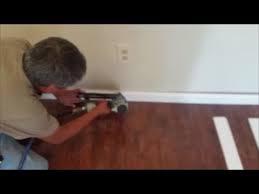 Measure the length of each wall to determine the necessary length for each piece of plastic baseboard molding. Install Baseboard Trim To Laminate Floor Using Pvc Trim New Installation Youtube
