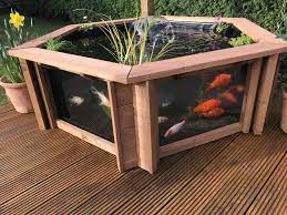 Remove the liner and add about 3 inches of sand to the bottom of the hole to raise the edge of the pond a couple of inches above the ground. Lily Clear View Garden Aquarium Raised Hexagon Pond Etsy Raised Pond Aquarium Pond Plants
