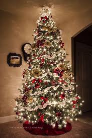 Ribbons of gold and red along a combination of christmas globes and poinsettias of the same color are a successful combination. Most Pinteresting Christmas Trees On Pinterest Christmas Celebration All About Christmas Beautiful Christmas Christmas Decorations Traditional Christmas Tree