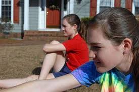Kristen, 14, (foreground) and Lauren Stephenson stretch