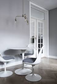 Introduced in 1955, the pedestal or tulip collection features chairs, tables and stools with a modern, streamlined interpretation of organic form. Tulip Table And Chairs Roomhints