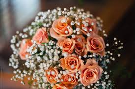 Baby's breath used to be synonymous with sad looking plastic wrapped red rose grocery store bouquets. Closeup Of A Bridal Bouquet With Peach Roses And Baby S Breath By Jessica Byrum Rose Baby S Breath