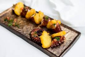 Lobos meat & tapas is a real carnivore's paradise, focusing on the prime cuts of iberico pig: Spanish Octopus And Potatoes Tapa Stockphoto