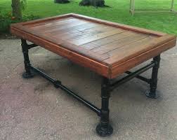 This rustic, modern coffee table is made from 2x8s, angle irons and black iron pipe. Iron And Pallet Coffee Table Pallet Furniture Plans