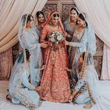 Indian Bride And Bridesmaids In Wellgroomed Red Bridal Lehenga And Blue Bridesmaid Lehe Indian Bridesmaids Indian Bridesmaid Dresses Indian Wedding Bridesmaids