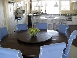 White cabinets make the space feel large and airy. Custom Farm Tables Reclaimed Wood Furniture Round Dining Room Table Round Dining Table Round Dining Room
