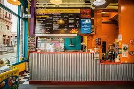 Two tamales made of masa (corn dough) filled with chicken, pork, or cheese and steamed inside a corn husk. Taco Del Sol Helena Mt