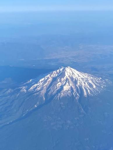 Mount Shasta in the Cascades from airplane window