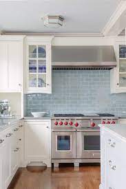 Throughout a weekend or two, you can make a chic and practical backsplash out of the subway. White Kitchen Cabinets With Blue Glazed Subway Tiles Transitional Kitchen