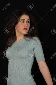 Beautiful Closeup Of A Sensual Young Brunette Teen. Bring A Knitted Dress.  Close-up Highlighting The Breasts. Uniform Black Background Stock Photo,  Picture and Royalty Free Image. Image 102442520.