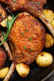 Closeup Of Stove Top Pork Chops With A Perfect Golden Crust And Sauteed Potatoes On The Side Pan Fried Pork Chops Pork Chop Recipes Grilled Cooking Pork Chops