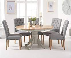 Franklin concrete dining table and bench with 2 perth grey velvet chairs (black legs) £699.99. Epsom Oak And Grey Pedestal Extending Dining Table With Claudia Grey Fabric Dining Chairs Grey Dining Tables Oak Dining Furniture Oak Dining Chairs