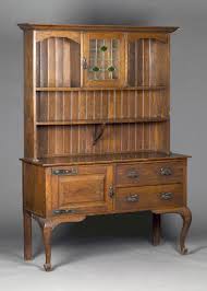They're also perfect statement pieces that complement your room's style. An Edwardian Arts And Crafts Oak Dresser The Angular Pediment Above A Leaded Glass Cupboard And She