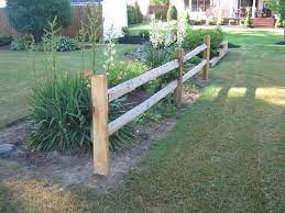 Enhancing the front of a split rail fence with flowers creates a rustic look attractive in the city as well as the country. Split Rail Sadler Fence And Staining