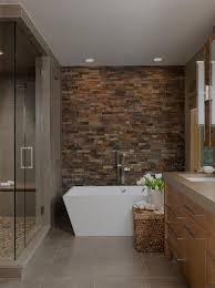 By keeping the walls and the vanity simple and neutral, the designer is able to experiment with the shower and floor tiles and create a load of visual interest with this starburst pattern. 27 Absolutely Gorgeous Bathroom Design Ideas With Brick Walls Stone Tile Bathroom Natural Stone Bathroom Stone Bathroom